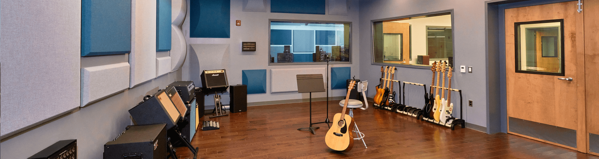 A recording studio for musicians with numerous guitars.