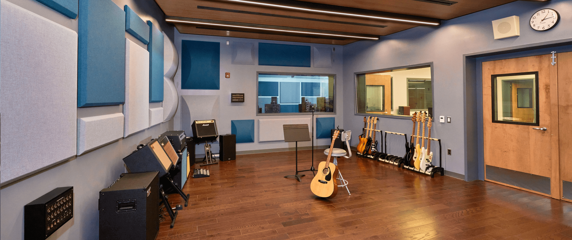 A recording studio for musicians with numerous guitars.