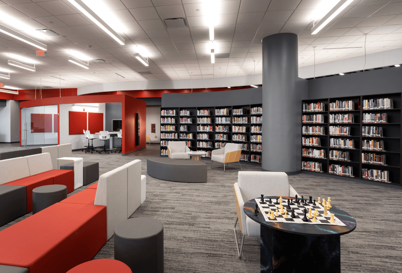 A school library with red seating accents.