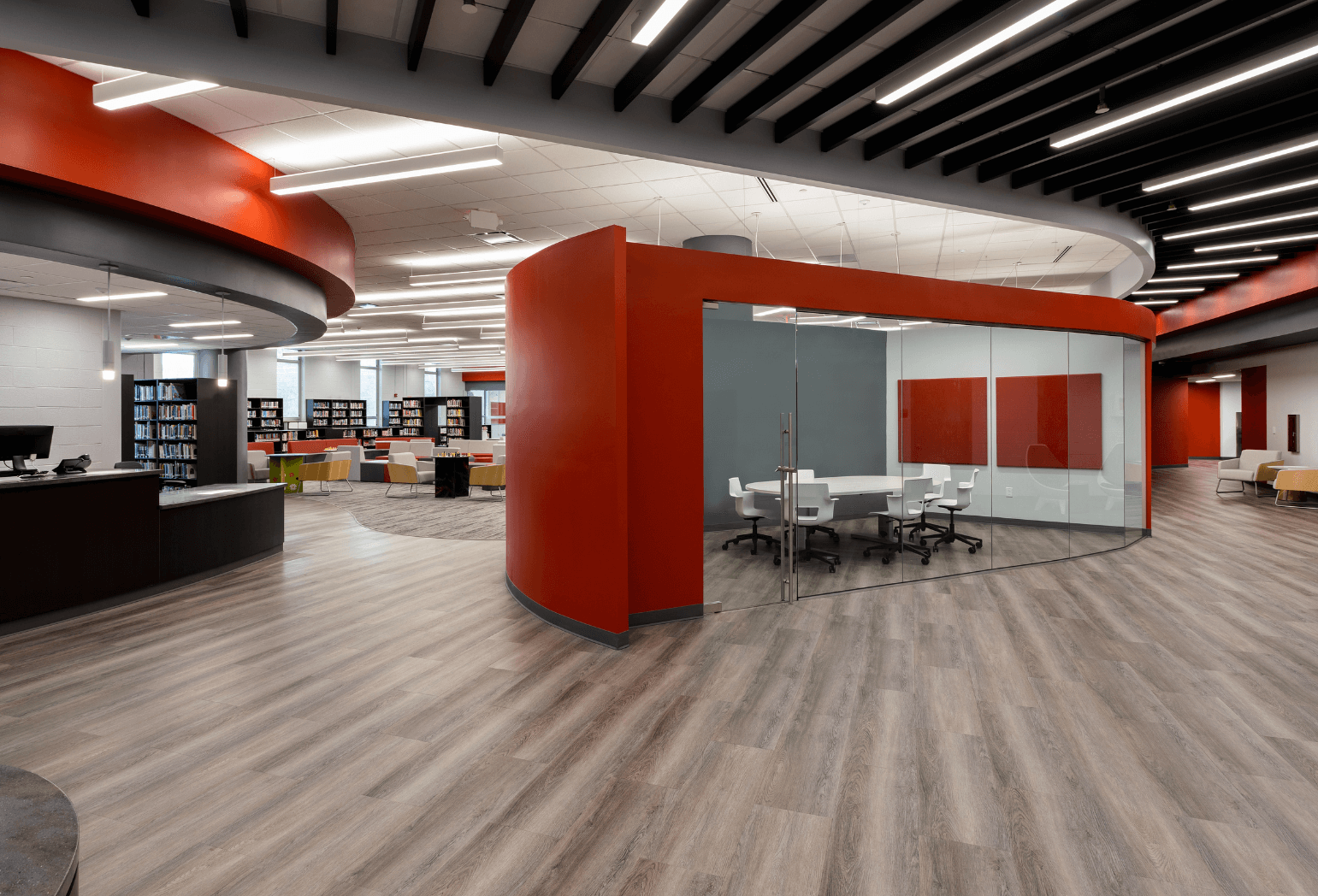 A library with red accents and a private conference room.