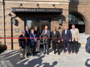 People cutting a ribbon for the new civic center in Somerville, NJ.