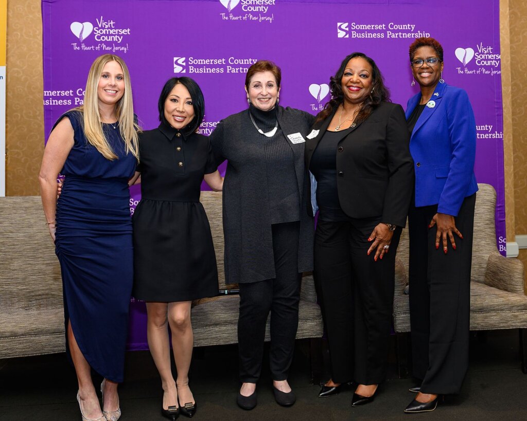 A photo of five women Jeanne Perantoni, middle with, from left, event moderator Kayla George, Shani Madaminova, Nanette Lee, and Sharel Robinson, who spoke at the Somerset County Business Partnership’s 2024 International Women’s Day event.